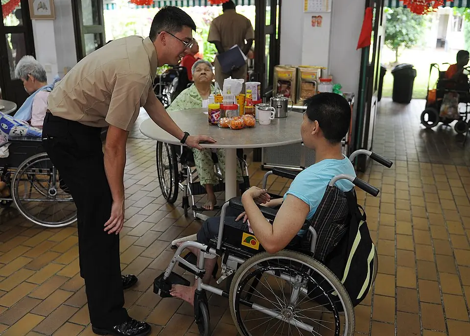 Caretaker assisting an elderly person at home